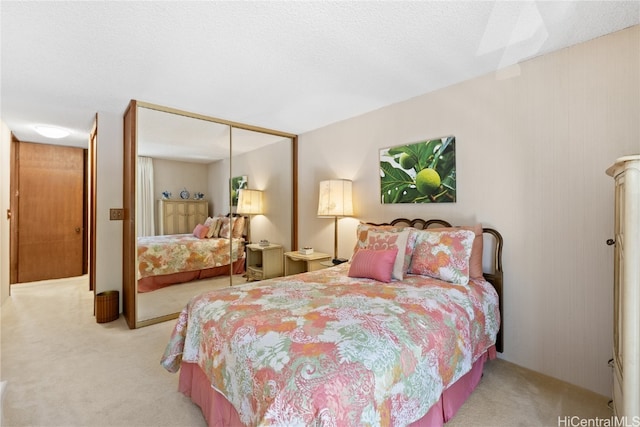 carpeted bedroom featuring a closet and a textured ceiling