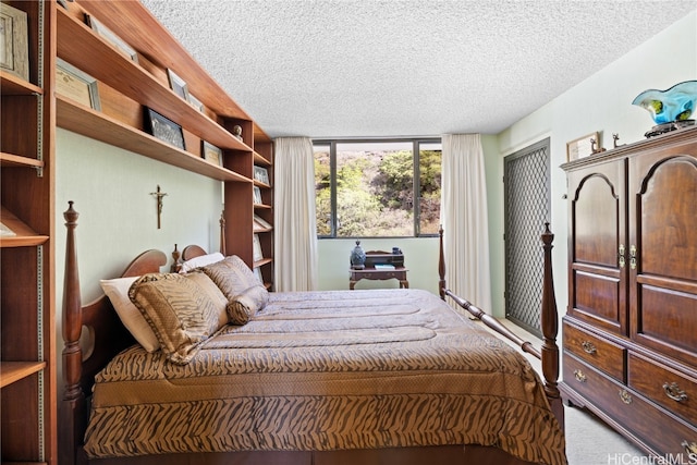 carpeted bedroom featuring a textured ceiling