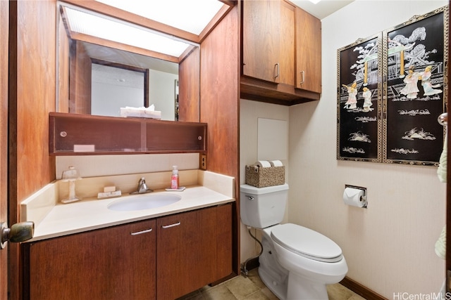 bathroom featuring tile patterned flooring, vanity, and toilet