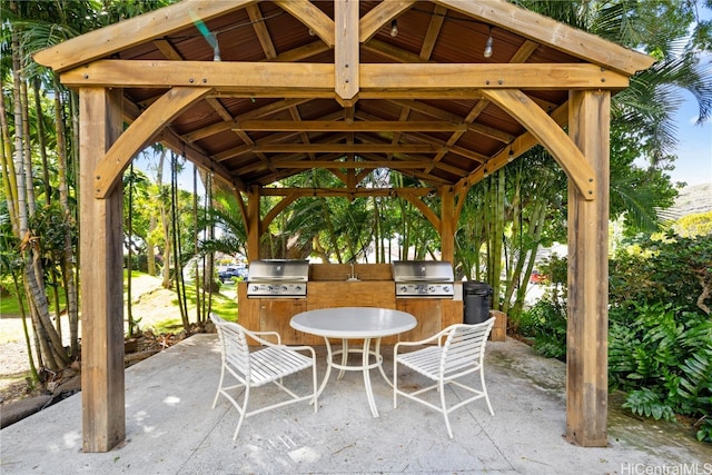 view of patio with a gazebo, an outdoor kitchen, and grilling area