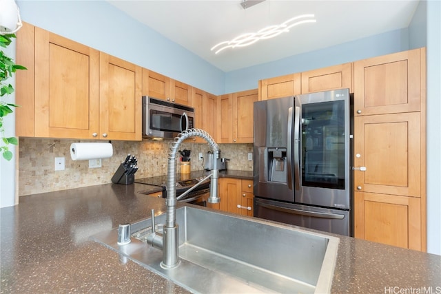 kitchen featuring backsplash, light brown cabinets, sink, and appliances with stainless steel finishes