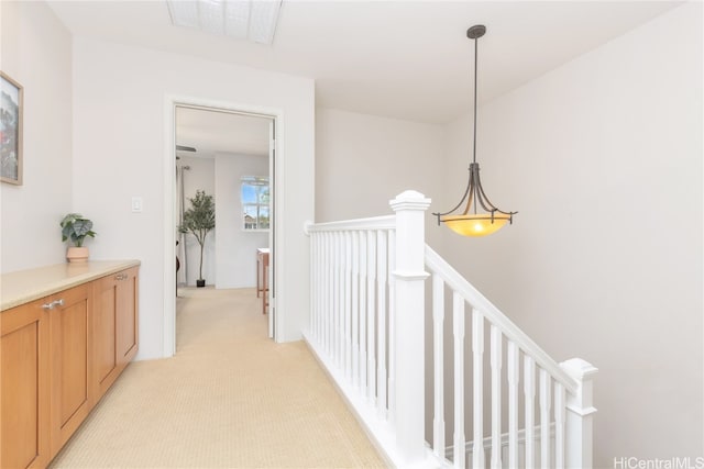 hall featuring light colored carpet