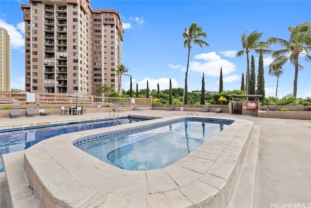 view of pool with a patio area and a community hot tub