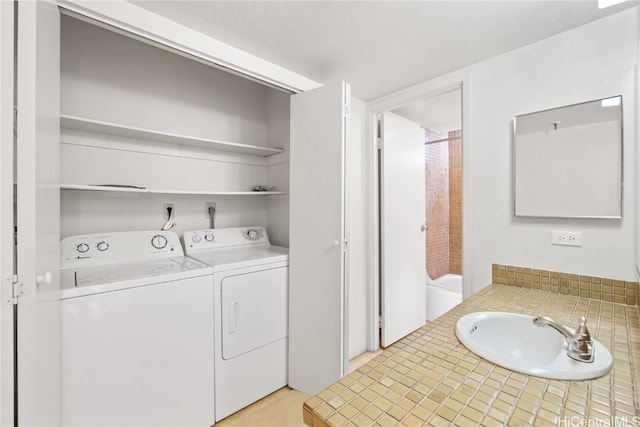 laundry room featuring sink and washer and dryer