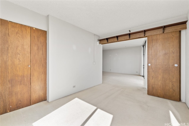 carpeted bedroom with a closet and a textured ceiling