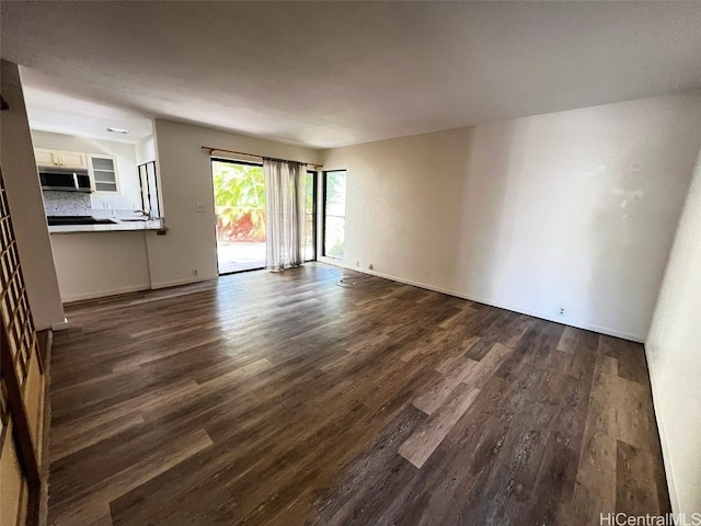 unfurnished living room featuring dark wood-type flooring