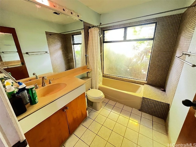 full bathroom featuring shower / bath combo with shower curtain, tile patterned flooring, vanity, and toilet