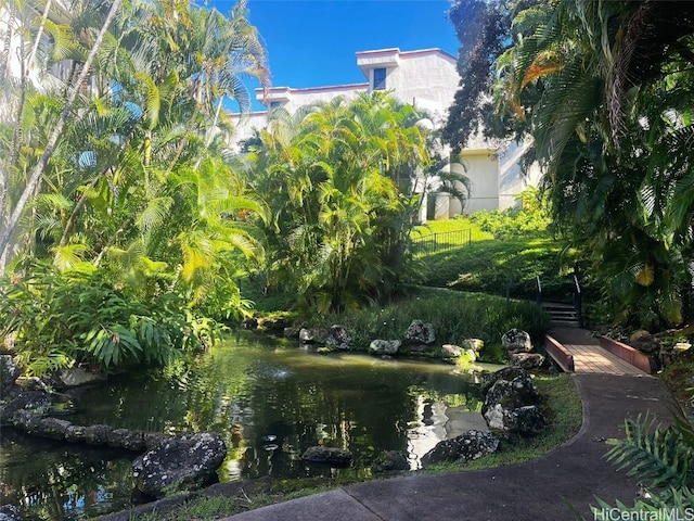 view of community with a garden pond