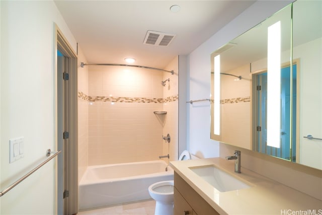 full bathroom featuring toilet, vanity, and tiled shower / bath combo