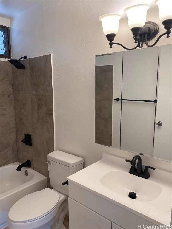 full bathroom with tiled shower / bath combo, toilet, and vanity