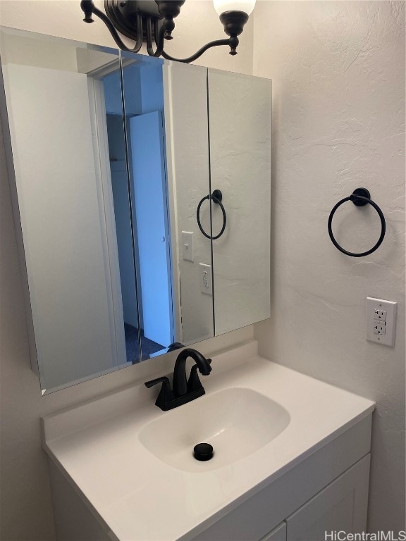 bathroom with vanity and an inviting chandelier