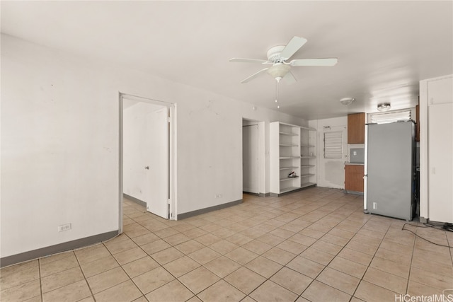 interior space featuring light tile patterned floors and ceiling fan