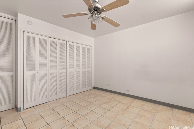 unfurnished bedroom with ceiling fan and light tile patterned floors