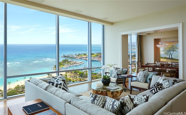 living room with hardwood / wood-style flooring, plenty of natural light, and a water view