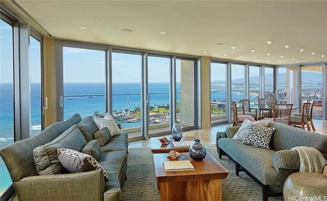 sunroom featuring a water view and a wealth of natural light