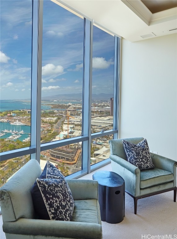 interior space featuring carpet floors, floor to ceiling windows, and a water view