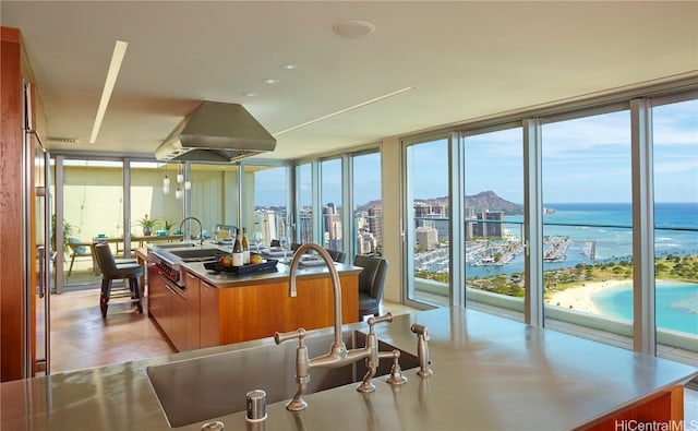 kitchen featuring floor to ceiling windows, a water view, and a wealth of natural light