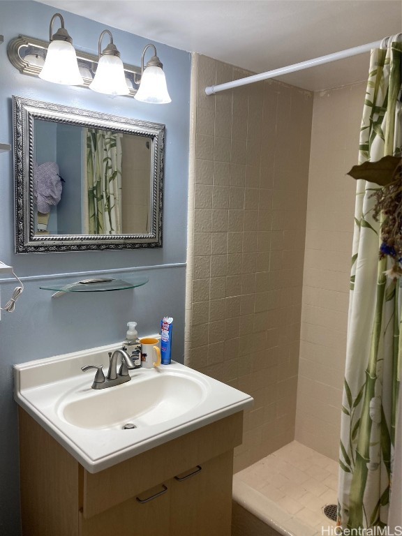 bathroom with curtained shower and vanity