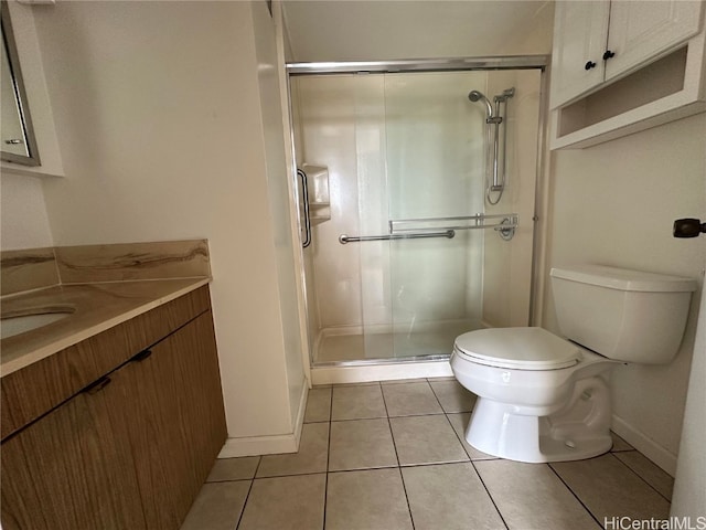 bathroom with toilet, vanity, tile patterned floors, and a shower with door