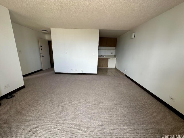 unfurnished room featuring a textured ceiling and light colored carpet