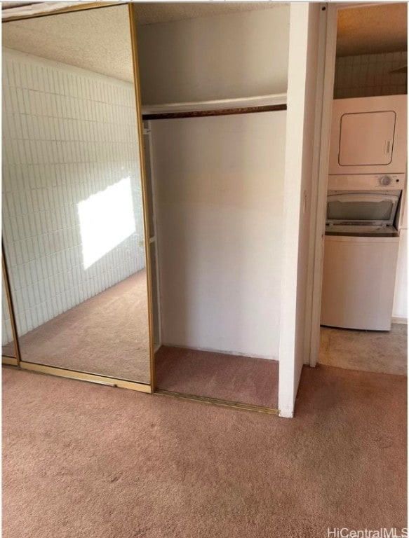 closet with stacked washing maching and dryer