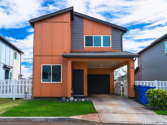 contemporary house featuring a carport, a garage, and a front yard