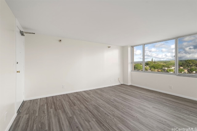 unfurnished room with hardwood / wood-style floors