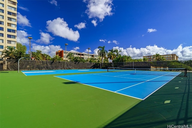 view of tennis court with basketball hoop