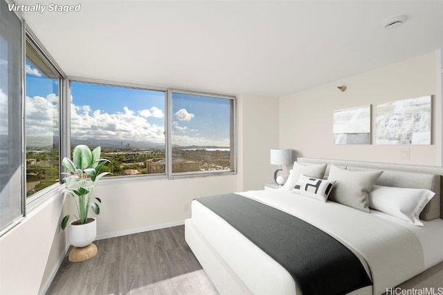 bedroom with hardwood / wood-style flooring