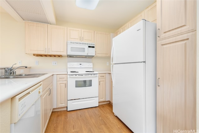 kitchen with sink, white appliances, and light wood-type flooring