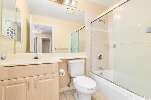 full bathroom featuring tile patterned flooring, vanity, enclosed tub / shower combo, and toilet