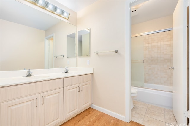 full bathroom with toilet, vanity, combined bath / shower with glass door, and hardwood / wood-style flooring