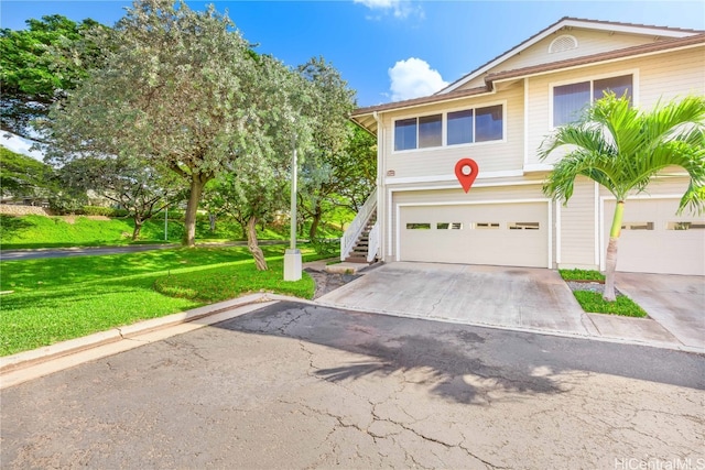 view of front of house with a front yard and a garage