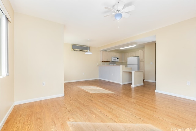 unfurnished living room featuring light wood-type flooring and ceiling fan