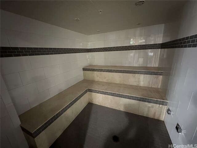 bathroom with tile walls