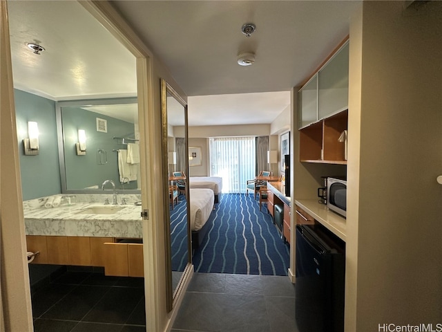 interior space featuring sink and dark tile patterned floors