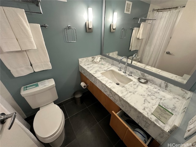 bathroom featuring tile patterned floors, vanity, and toilet