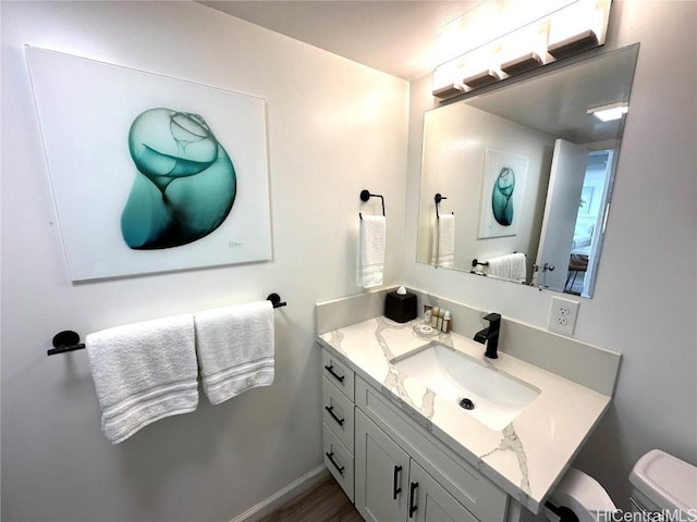 bathroom with vanity and toilet