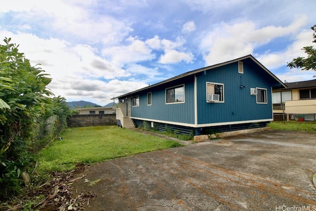 view of property exterior featuring cooling unit and a yard