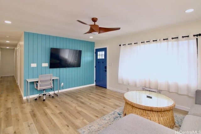 living room with hardwood / wood-style flooring and ceiling fan