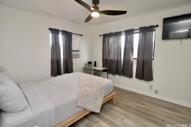 bedroom with ceiling fan and hardwood / wood-style flooring