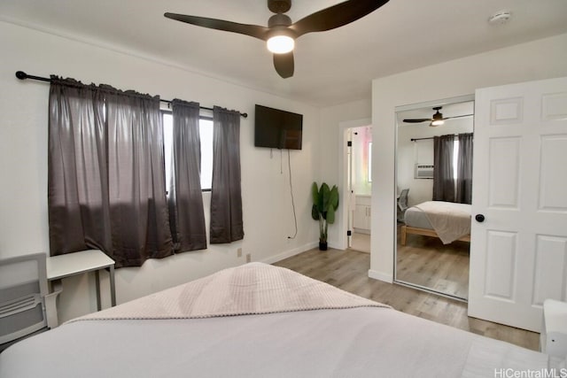 bedroom with ceiling fan, light hardwood / wood-style floors, ensuite bathroom, and a closet