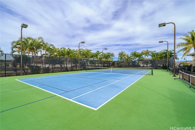 view of tennis court with basketball hoop