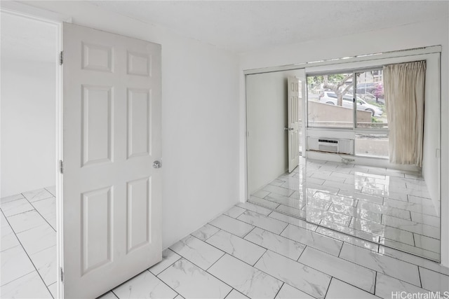 hallway featuring a wall unit AC