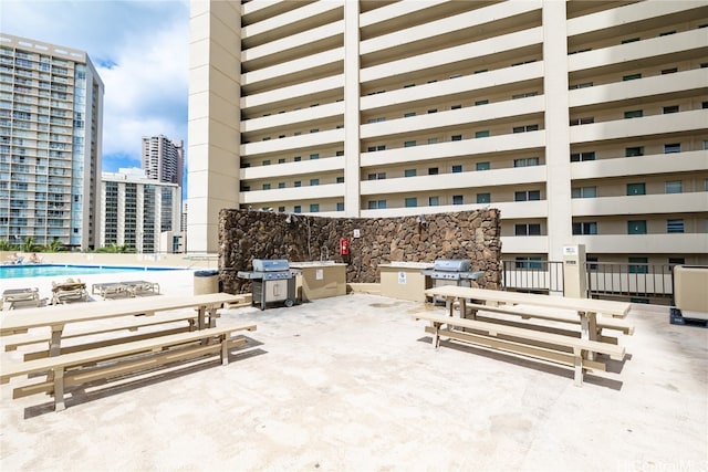 exterior space featuring a community pool and a grill