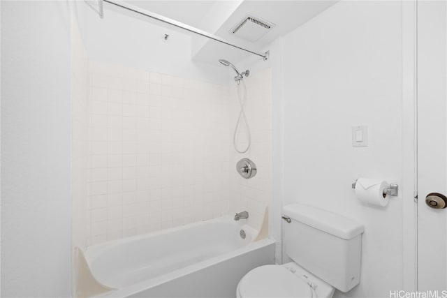 bathroom featuring toilet and tiled shower / bath