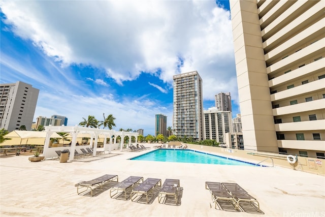 view of pool with a pergola and a patio