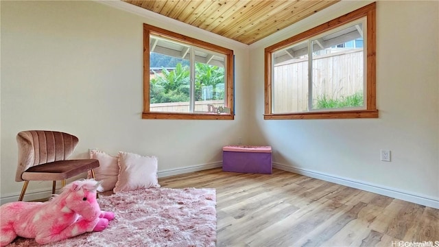 bedroom with ornamental molding, wooden ceiling, baseboards, and wood finished floors