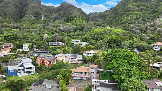 drone / aerial view featuring a wooded view