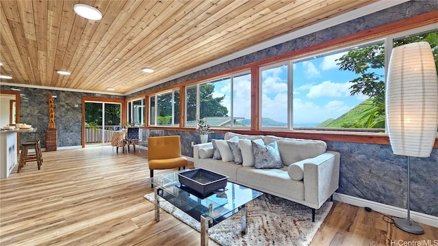 sunroom / solarium featuring a wealth of natural light and wooden ceiling